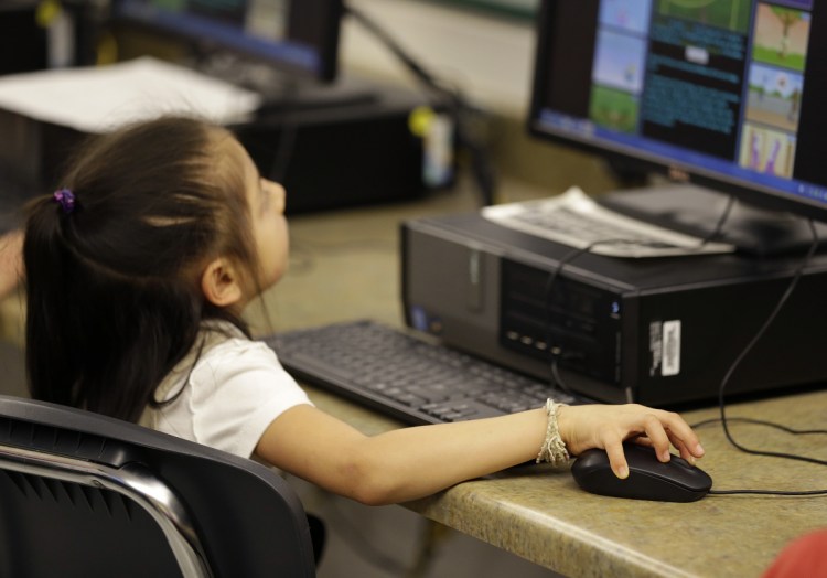 A first-grader practices keyboarding skills at Bayview Elementary School in San Pablo, Calif. in 2015. Amazon and other tech companies are pushing the nation's schools to teach coding.