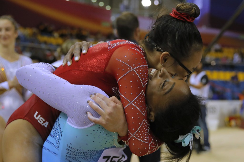Morgan Hurd, top, a former world champion, hugs Simone Biles after Biles captured the title Thursday for the fourth time. Hurd finished third. Both are from the United States.