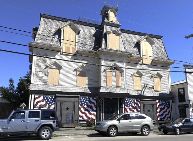 The windows of Robert Indiana's Star of Hope home on Main Street in Vinalhaven are boarded up. After roof repairs to stop leaks, the building will be winterized and closed until spring. It will ultimately undergo complete restoration and conversion to a museum in accordance with Indiana's will.