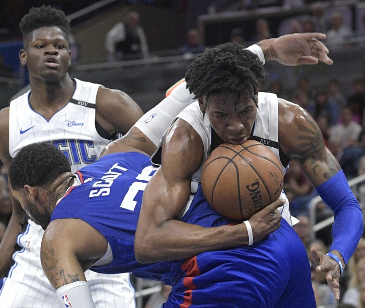 Orlando's Wesley Iwundu, right, is fouled by Mike Scott of the Clippers after grabbing a rebound in Friday's game at Orlando, Fla.