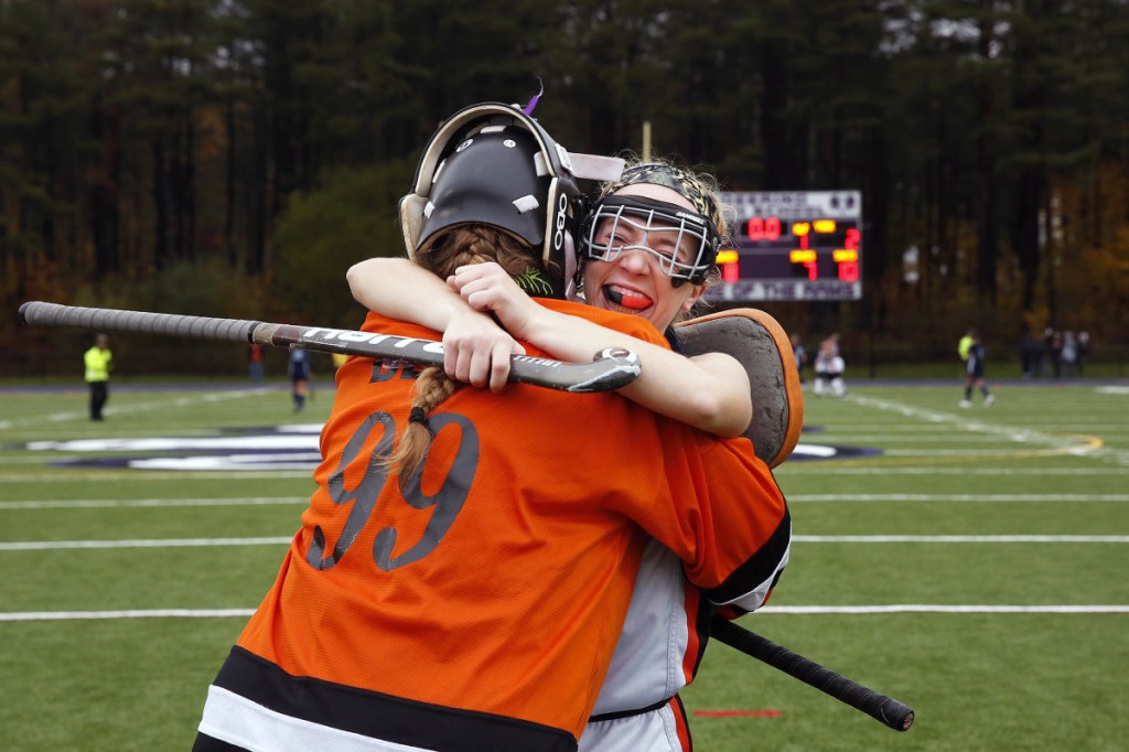 Gardiner High goalkeeper Lindsey Bell and teammate Amanda Cameron embrace after defeating York, 3-2, in the Class B state championship Saturday at Deering High School in Portland.