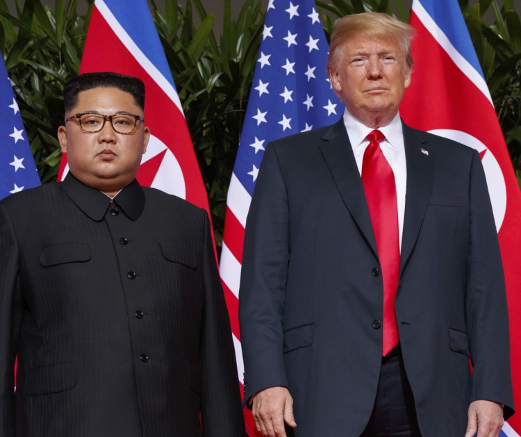 President Trump stands with North Korean leader Kim Jong Un on Sentosa Island in Singapore on June 12.