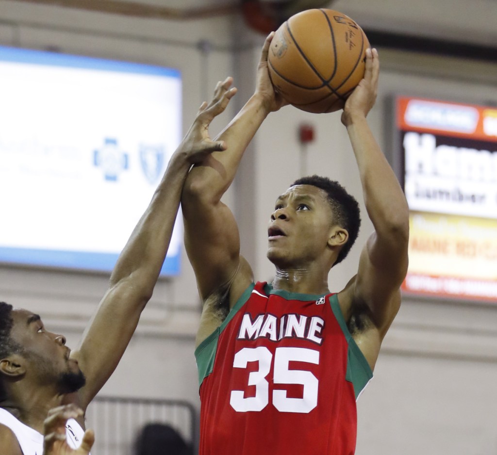 P.J. Dozier, who scored 26 points Sunday for the Maine Red Claws, lifts a shot over Shake Milton of the Delaware Blue Coats during a 132-124 victory.