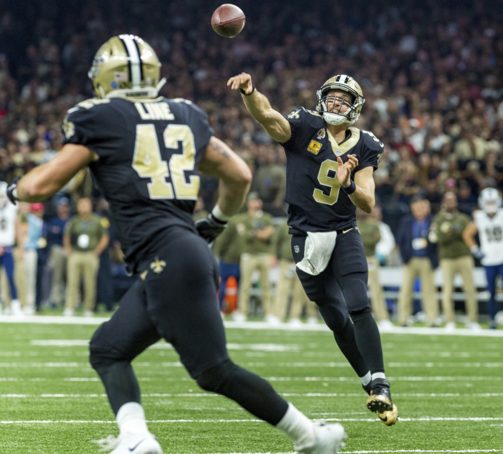Drew Brees of the New Orleans Saints tosses a pass to Zach Line during the Saints' 45-35 victory Sunday against the previously undefeated Los Angeles Rams.