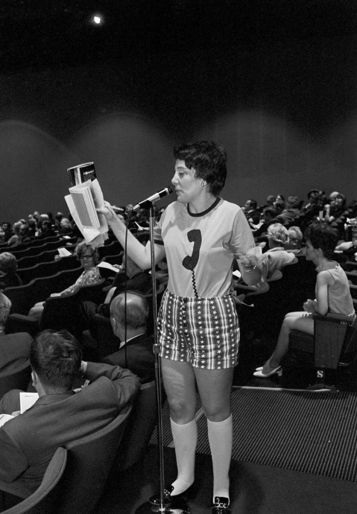 Evelyn Y. Davis wears hotpants as she speaks in May 1971 at the annual stockholders meeting of the Communications Satellite Corp. in Washington. Davis, who owned stock in more than 80 public companies and liked to make a show of her presence at shareholder meetings, died Sunday at age 89.