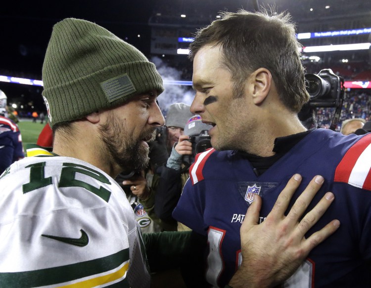 Aaron Rodgers of the Green Bay Packers, left, and Tom Brady of the New England Patriots are two great quarterbacks in totally different situations.