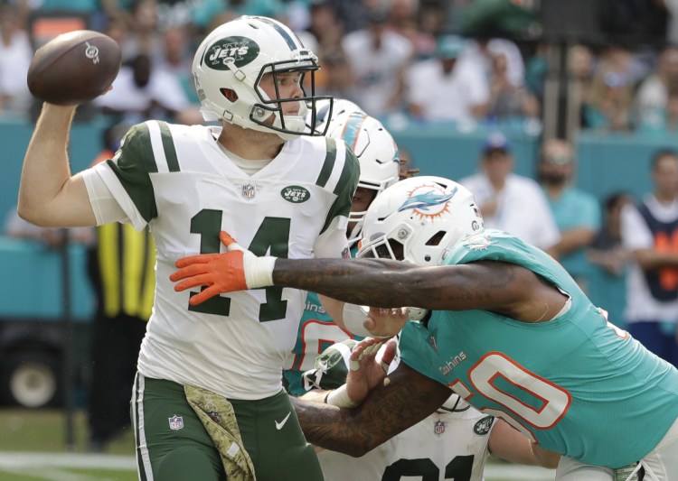 New York Jets quarterback Sam Darnold, pressured Sunday by Andre Branch of Miami, is putting the burden on himself for a three-game losing streak.