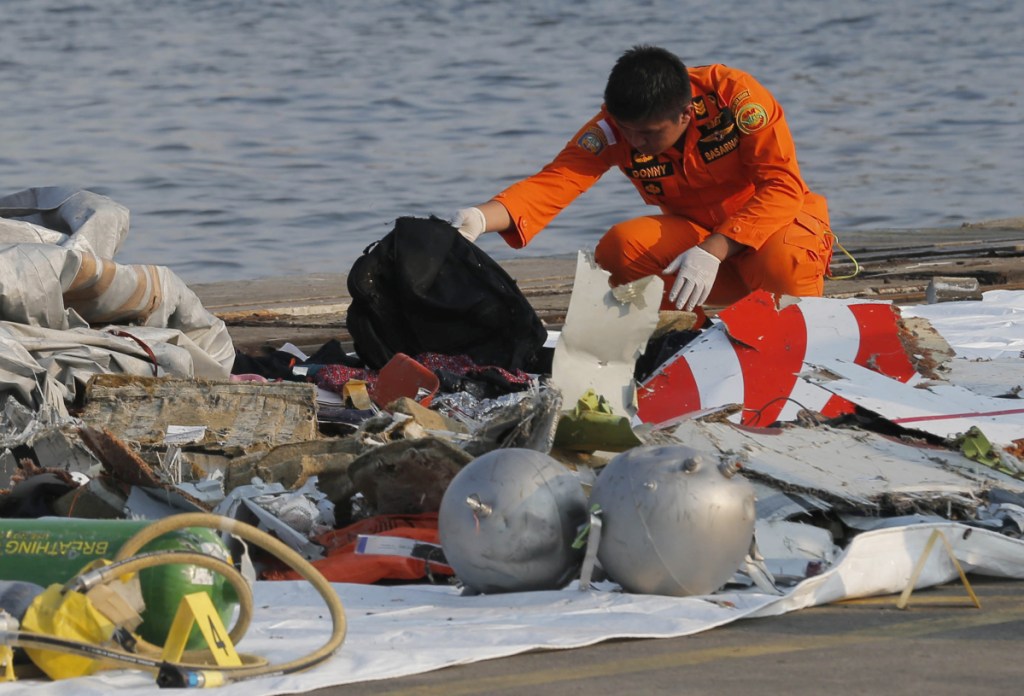A member of Indonesian Search and Rescue Agency inspects debris believed to be from a Lion Air passenger jet that crashed into the sea off Java Island at Tanjung Priok Port in Jakarta, Indonesia, on Oct. 29.