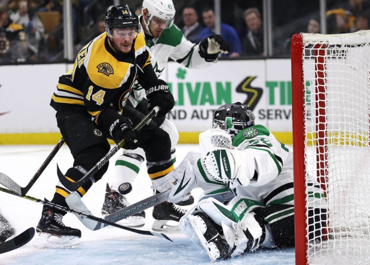 Dallas Stars goaltender Anton Khudobin, right, makes a save on a shot by Boston Bruins right wing Chris Wagner, left, during the second period of their game Monday in Boston.