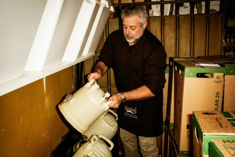 Jimmy Streit handles a plastic keg in the cellar of his bar in Copenhagen. Carlsberg has rolled out the technology more aggressively than other brewers.