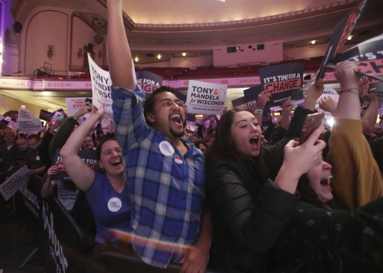 Supporters of Wisconsin Democratic gubernatorial candidate Tony Evers celebrate has he takes the stage during a post-election party at the Orpheum Theater in Madison, Wis., early Wednesday morning.