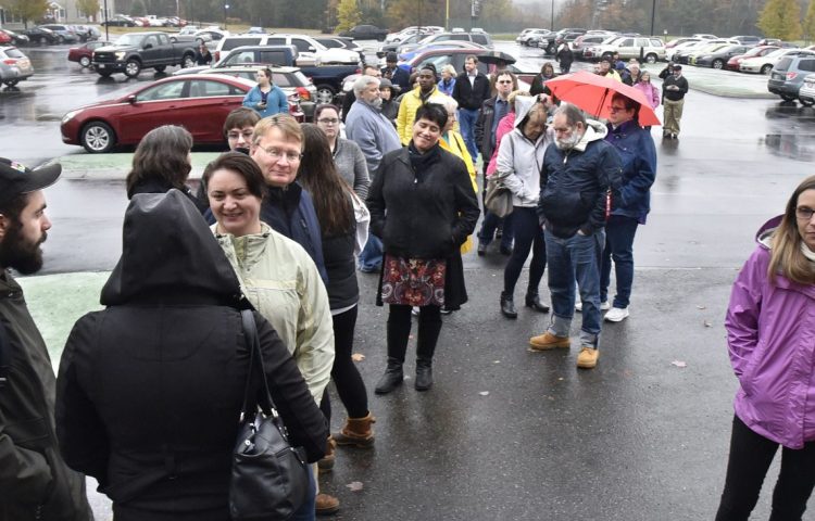 Voters wait in a long line for the polls to open early Tuesday at Thomas College in Waterville, a scene repeated at many other polling places.