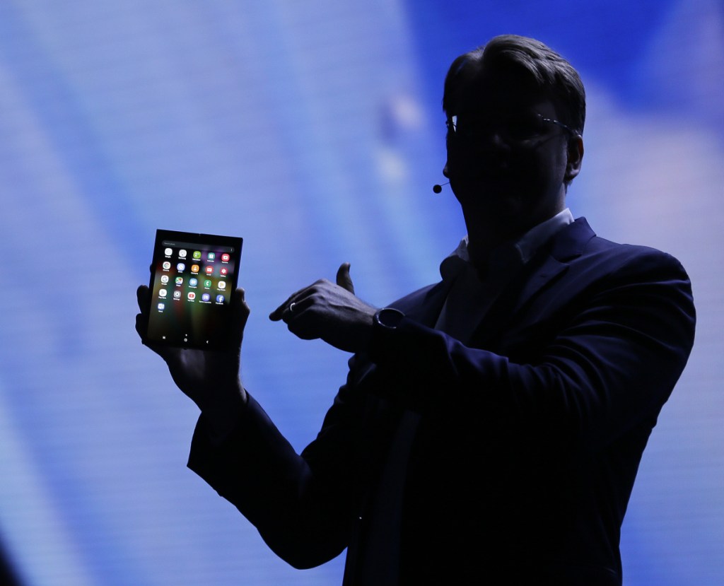 Justin Denison of Samsung shows off a folding smartphone during a developer conference Wednesday in San Francisco. Samsung says it will bring a smartphone with a bendable screen to market next year.