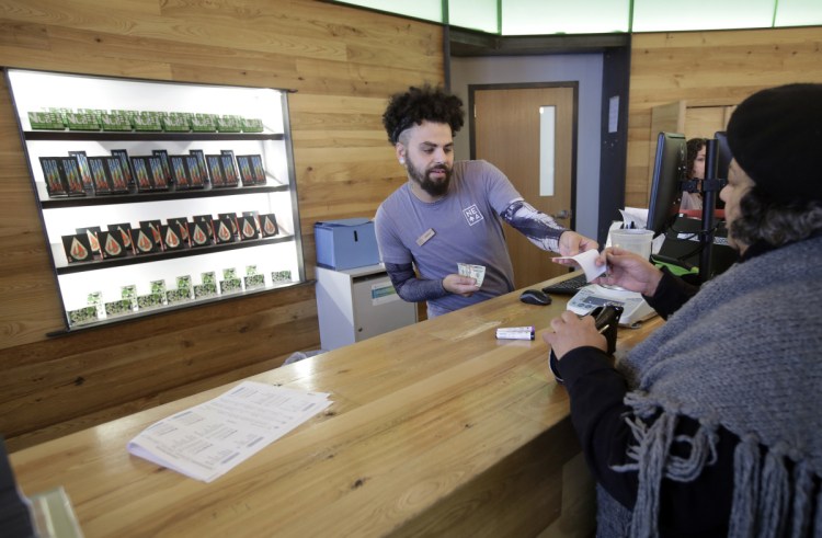 Nelson Rivera III sells medical cannabis products to Victoria Silva  at a New England Treatment Access medical marijuana dispensary, in Northampton, Mass. Within days perhaps, the medical marijuana dispensary in Northampton expects to receive the final go-ahead to sell recreational marijuana.