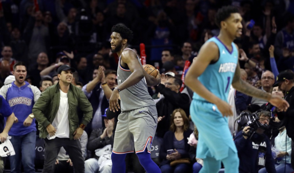 Philadelphia's Joel Embiid, center, celebrates after the 76ers beat the Charlotte Hornets 133-132 in overtime on Friday in Philadelphia. Emiid had 42 points and 18 rebounds.
