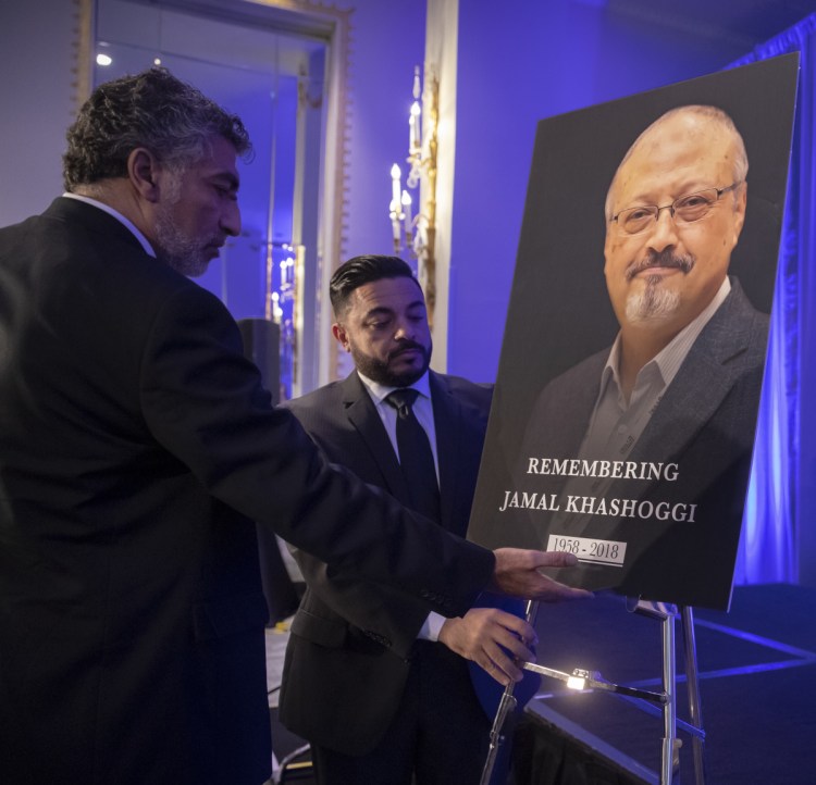 Mongi Dhaouadi, left, and Ahmed Bedier set up an image of slain Saudi journalist Jamal Khashoggi before an event this month to remember the Washington Post columnist, who was killed on Oct. 2.