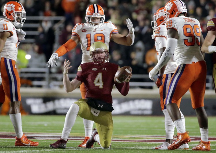 Boston College quarterback EJ Perry rises from the turf after being tackled during the second half of a game against Clemson Saturday night in Boston.