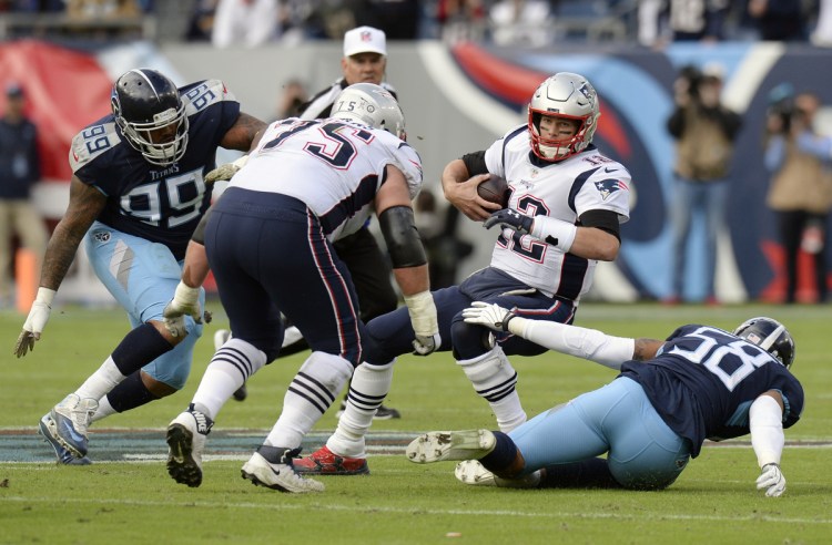 Patriots quarterback Tom Brady is sacked by Tennessee Titans linebacker Harold Landry for an 11-yard loss in the first half of New England's 34-10 loss to the Tennessee Titans on Sunday in Nashville, Tennessee.