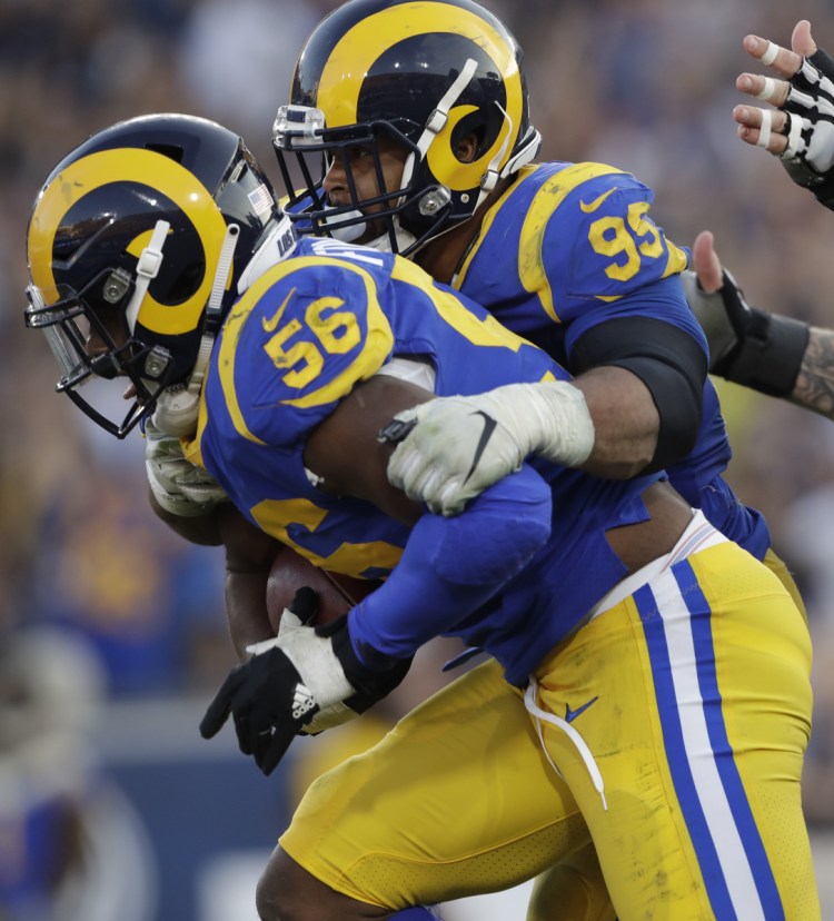 Dante Fowler of the Rams recovers a fumble Sunday against the Seattle Seahawks, helping Los Angeles hold on for a 36-31 win.