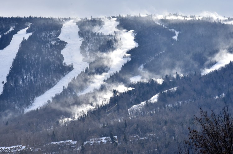 The Sugarloaf ski resort is covered with natural snow as well as man-made snow shot Monday from snow guns at right. The mountain opens Friday.