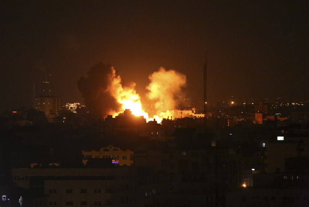 An explosion is caused by Israeli airstrikes on the Al-Rahma building in Gaza City on Monday. Palestinian militants fired hundreds of rockets and mortar shells into southern Israel, and the Israeli military responded by dispatching fighter jets to strike throughout the Gaza Strip. (AP Photo/Adel Hana)