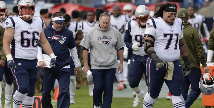 There was nothing to smile about Sunday for Coach Bill Belichick, center, and his Patriots players following their 34-10 dismantling by the Tennessee Titans in Nashville.