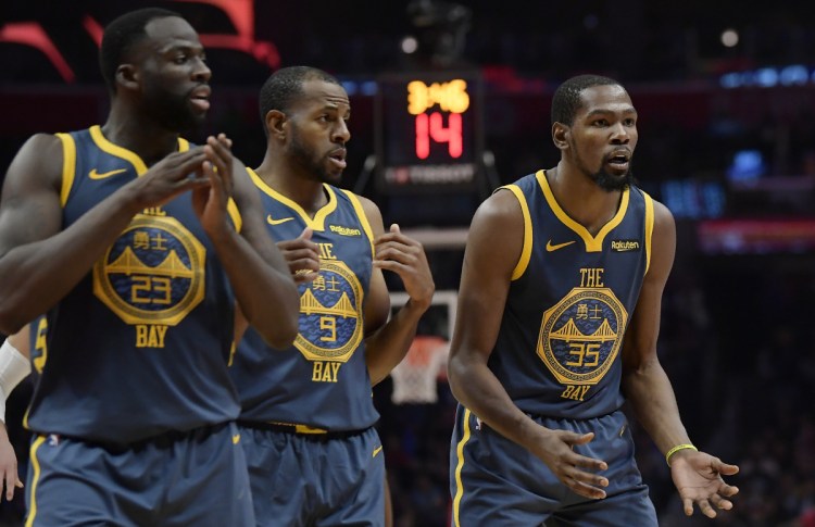 Draymond Green, left, and Kevin Durant, right, got into a heated exchange during Golden State's 121-116 overtime loss to the Clippers in Los Angeles on Monday, leading the Warriors to suspend Green for Tuesday's game against Atlanta.