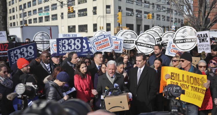 New York City Councilor Jimmy Van Bramer, center, speaks Wednesday during a rally of elected officials, community groups and unions opposing Amazon getting subsidies to locate in the New York neighborhood of Long Island City.