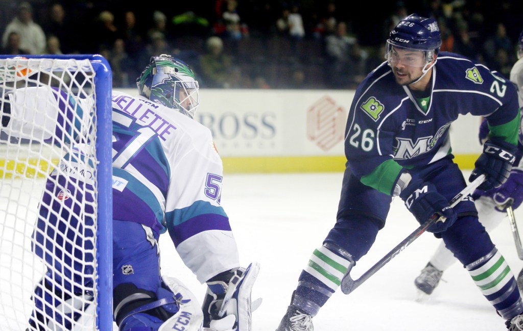 Shawn St. Amant flips the puck past Orlando Solar Bears goalie Martin Ouellette for one of his three goals Wednesday night, leading the Maine Mariners to a 6-3 win at Cross Insurance Arena.