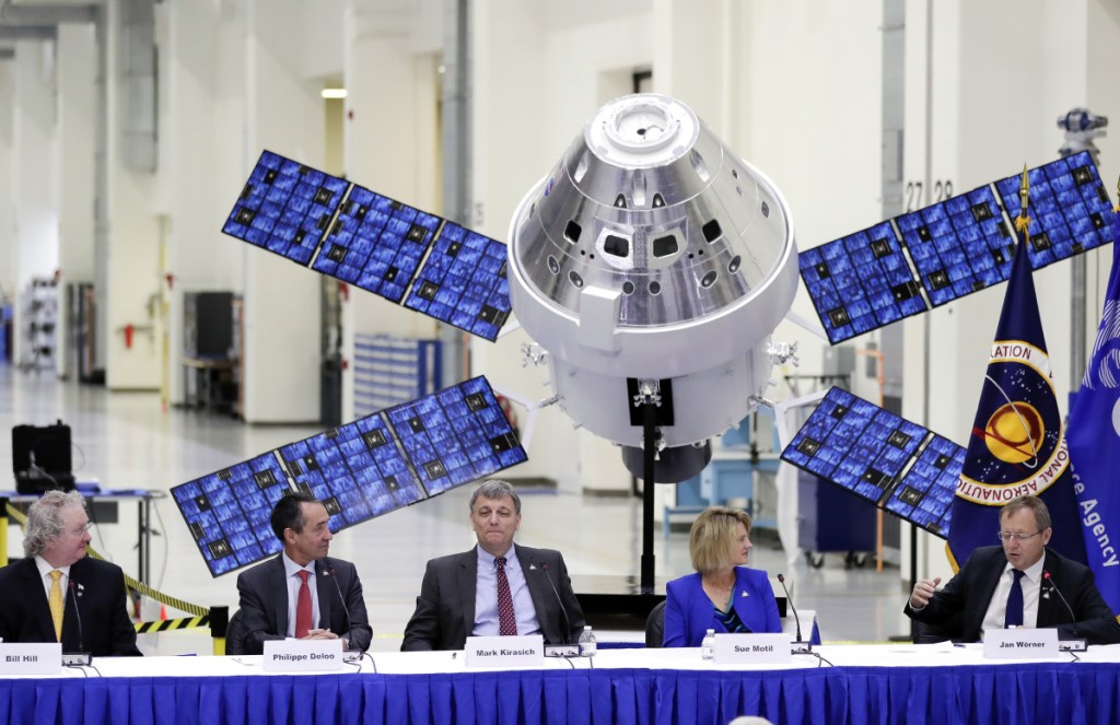 The European Space Agency's director general, Jan Worner, far right, answers questions Friday during a panel discussion with U.S. and European leaders at the Kennedy Space Center in Cape Canaveral, Fla. Behind them is a model of the Orion capsule and the service module.