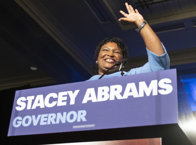 Georgia Democratic gubernatorial candidate Stacey Abrams speaks to supporters on Election Day. Abrams, who lost by 60,000 votes, says the election was tainted by too many irregularities.