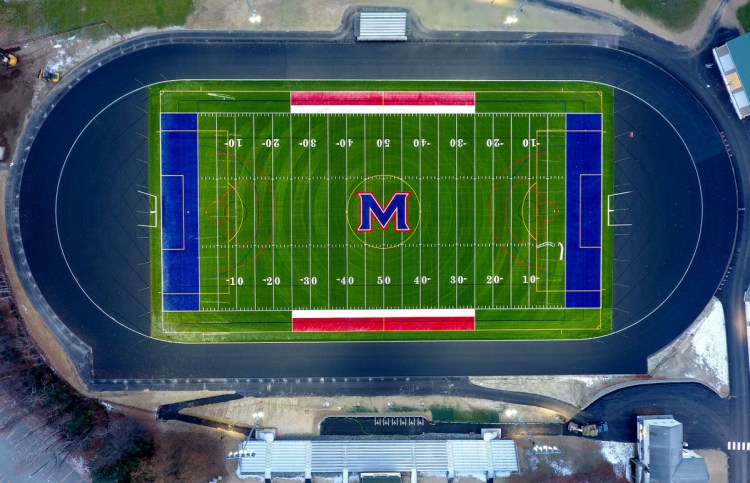 The new Messalonskee High School field for football, soccer and lacrosse, track and bleachers — seen in an aerial view from a drone on Thursday — is lit up with new lights at the Oakland school.