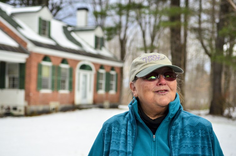 Dale Potter-Clark, standing near the brick house built in 1825, said, "We would all love to see that building saved."