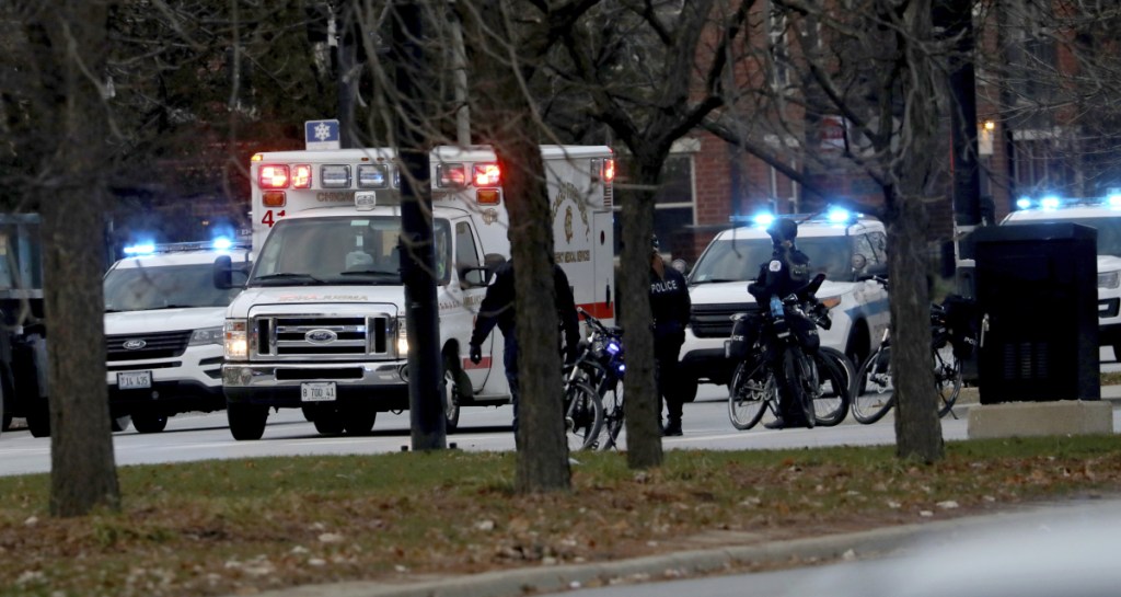 An ambulance believed to be carrying an injured Chicago police officer departs Mercy Hospital on Monday in Chicago.