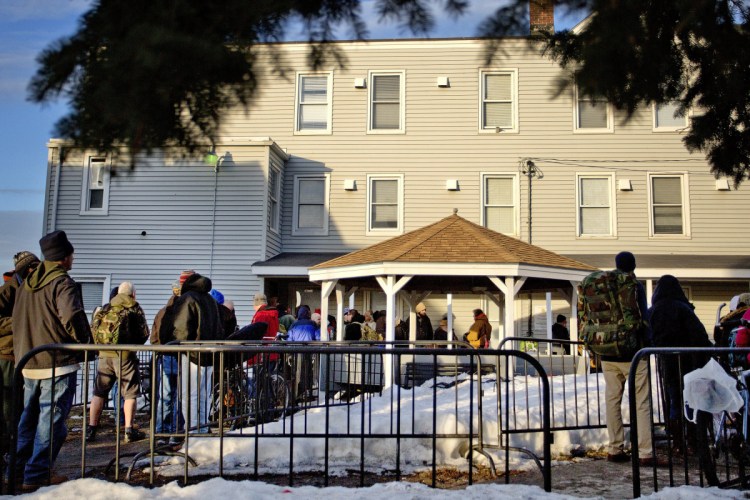 People wait in line in 2015 to enter the Oxford Street Shelter in Portland. The outdated and overcrowded facility has operated in Bayside for over 30 years.