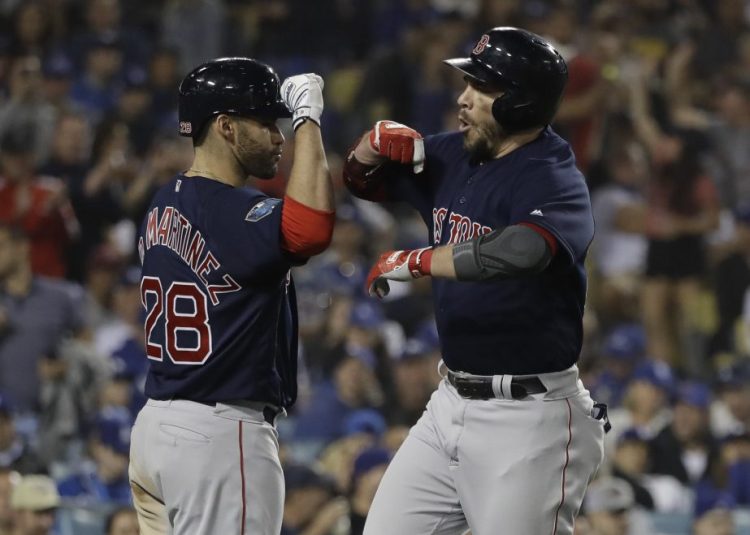 Boston's Steve Pearce celebrates his second home run of Game 5 of the World Series with J.D. Martinez. Pearce will return to the Red Sox after signing a one-year, $6.5-million contract.
