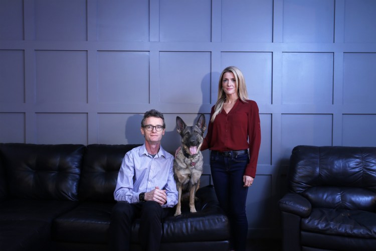 Hagen Blaszyk and Linda Murray pose for a portrait with Luna, a German Shepherd, in Murray's home. Blaszyk and Murray cofounded an organization that pairs veterans with service animals to help treat their PTSD.