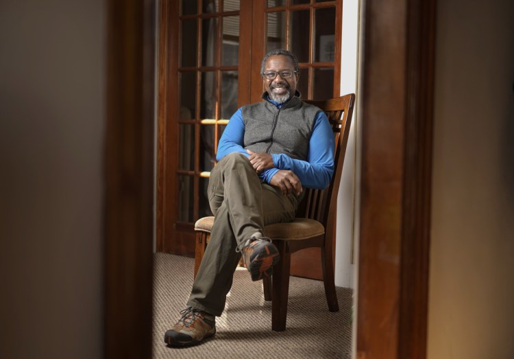 Therapist RJ Reid poses for a photo in the waiting room of his practice in South Portland on Monday, November 12, 2018. Reid started a group for people upset over the election of President Trump and they have transformed it into an informal agency that helps immigrants connect with services they need.
