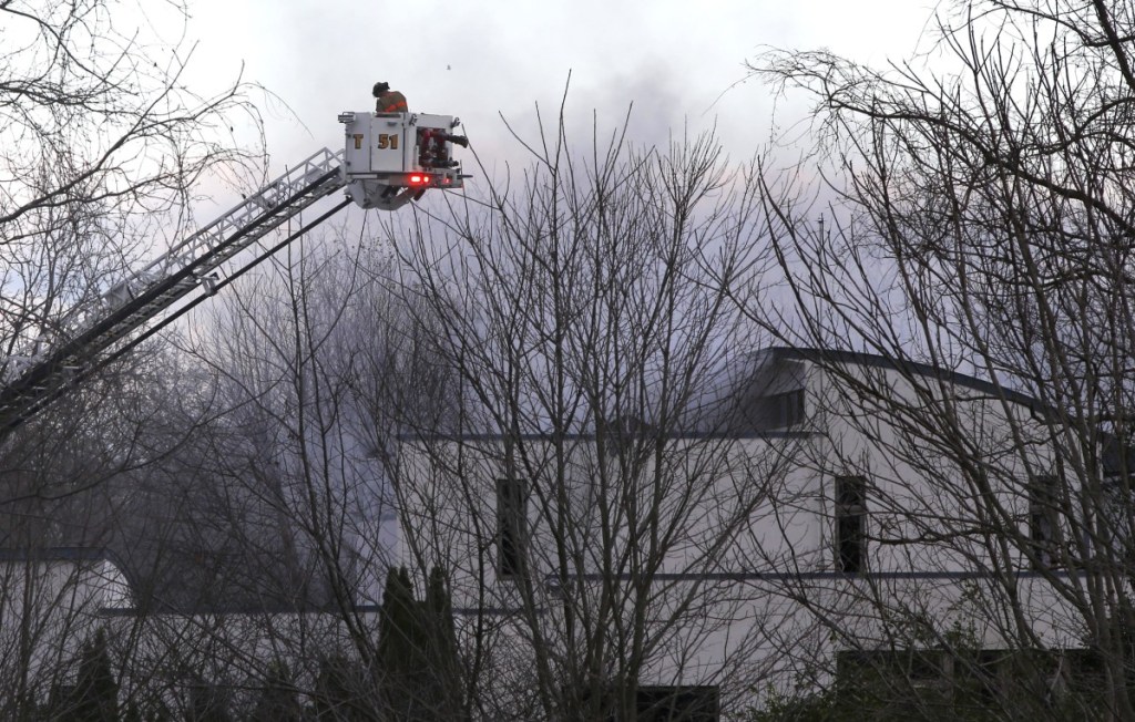 Firefighters work to extinguish a fatal fire in Colts Neck, New Jersey, on Tuesday. One of the owners is a technology CEO. A home owned by a relative who is vice president of the same company also burned Tuesday.