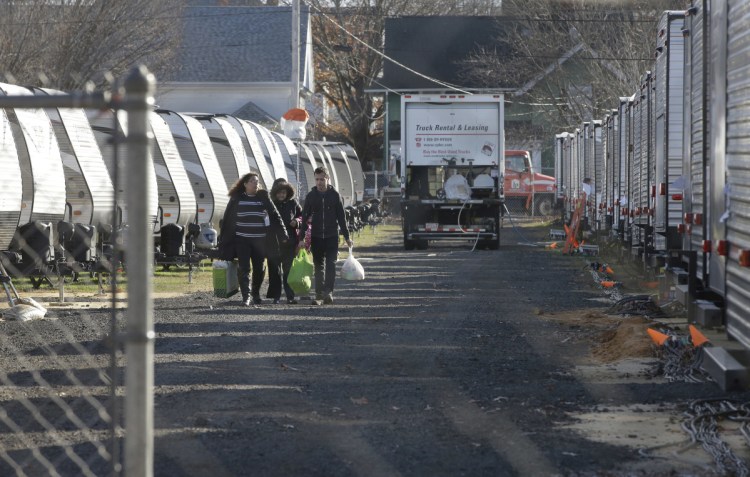 Sonia Geha, left, and her mother, Laila Eid, center, both of Lawrence, Mass., depart on Nov. 14 from a trailer camp for people affected by the natural gas line blasts that destroyed or damaged more than 200 homes.