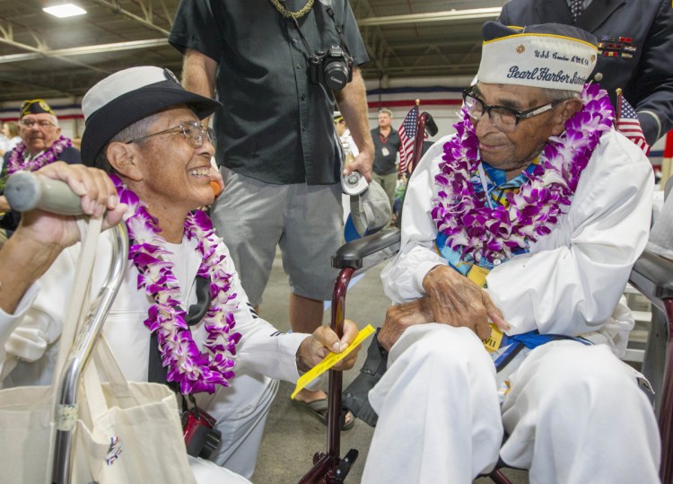 Kathleen Chavez talks with her father, Ray Chavez, on Dec. 7, 2016, at Pearl Harbor remembrance ceremonies in Honolulu.