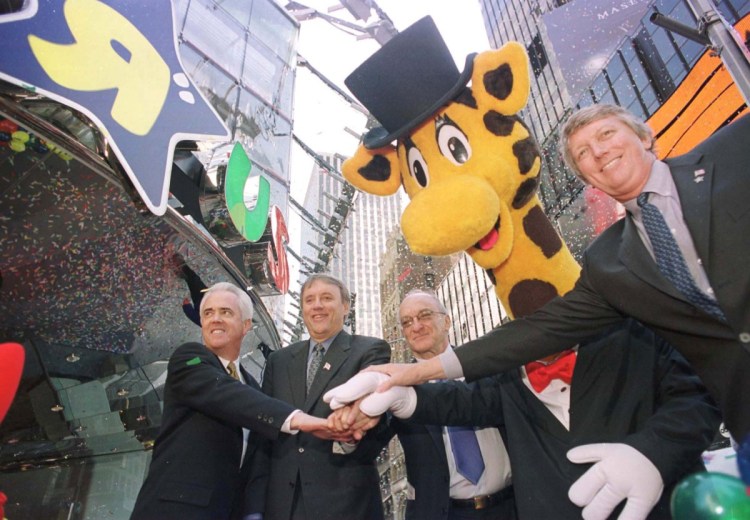 Officials mark the opening of a Toys R Us in New York's Times Square in 2001. The company that revealed in March that it would be closing and cutting loose 33,000 workers is back from the grave through a subsidiary.