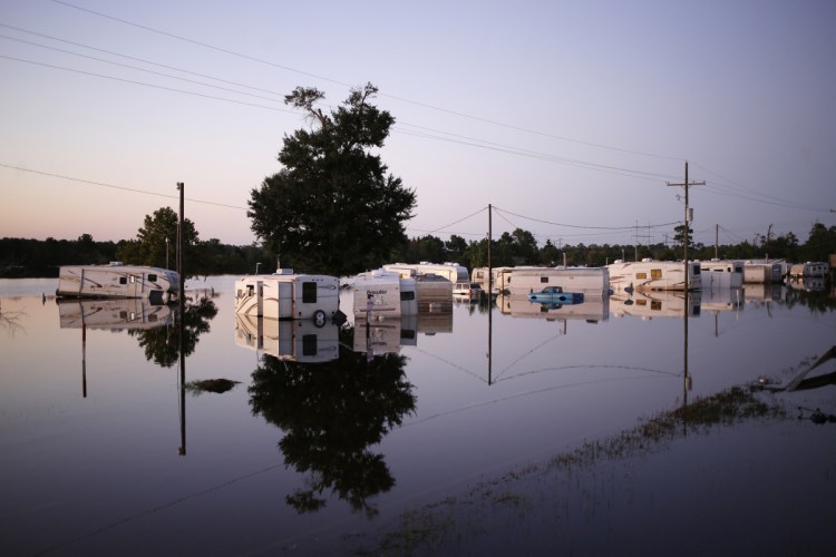 Vehicles and trailers are submerged Sept. 6 at a trailer park flooded by Hurricane Harvey in Rose City, Texas. Many storm-damaged structures are rebuilt stronger to withstand big storms.