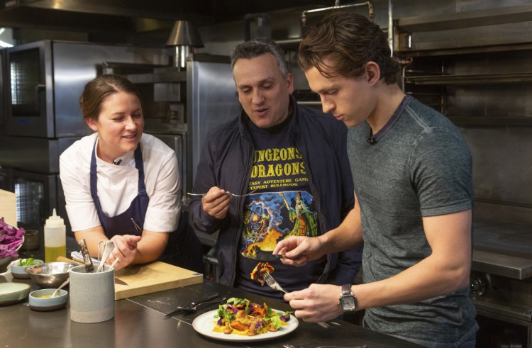 Chef Jessica Largey watches as "Avengers" co-director Joe Russo, center, and "Spider-Man" actor Tom Holland try a pumpkin dish she prepared.