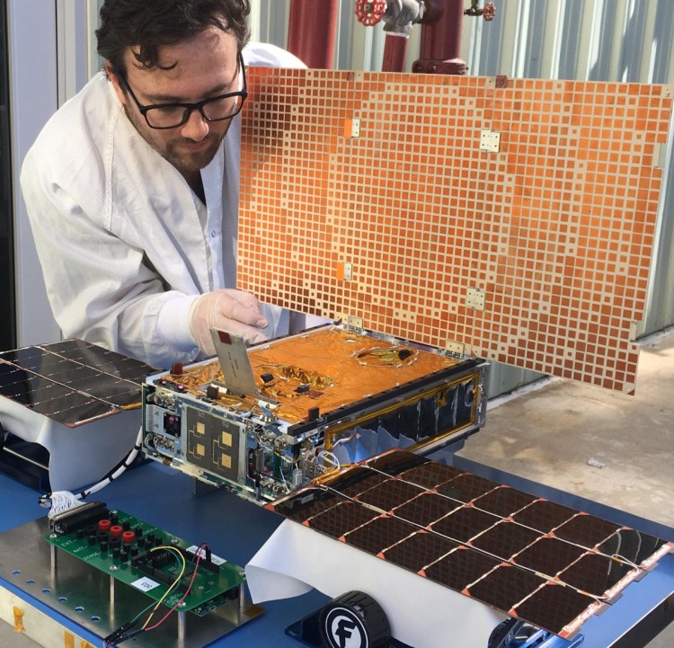 Engineer Joel Steinkraus uses sunlight to test the solar arrays on one of the Mars Cube One project spacecraft at NASA's Jet Propulsion Laboratory in Pasadena, Calif.