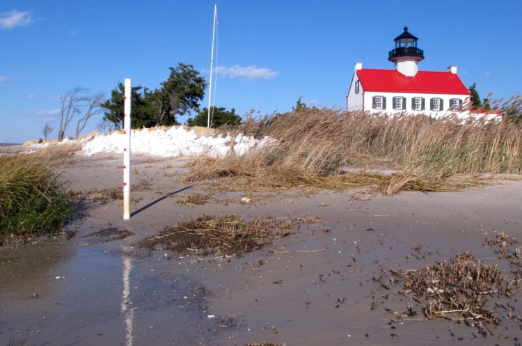 The waters of Delaware Bay encroach on East Point Lighthouse in Maurice River Township, N.J. Because of rising seas, "this lighthouse is in incredible danger," says advocate Nancy Patterson. "We need to do something – now – while there's still something to save."