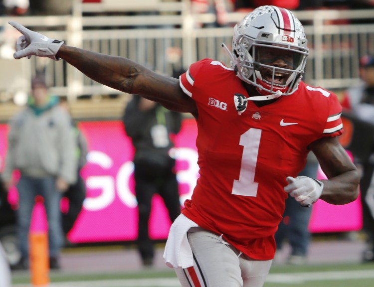 Ohio State receiver Johnnie Dixon celebrates a second-half touchdown against Michigan during the 62-39 victory Saturday.