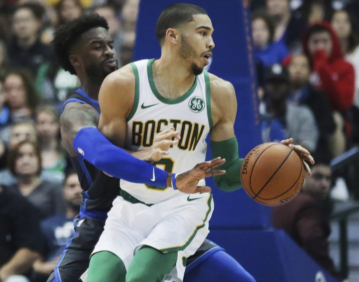 Boston forward Jayson Tatum attempts to move the ball while defended by Dallas guard Wesley Matthews during Saturday's game in Dallas.