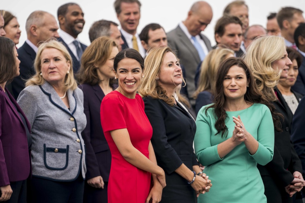 Alexandria Ocasio-Cortez stands on the steps of the U.S. Capitol with the 116th Congressional freshmen for the member-elect class photo. Ocasio-Cortez is the youngest woman ever elected to Congress.