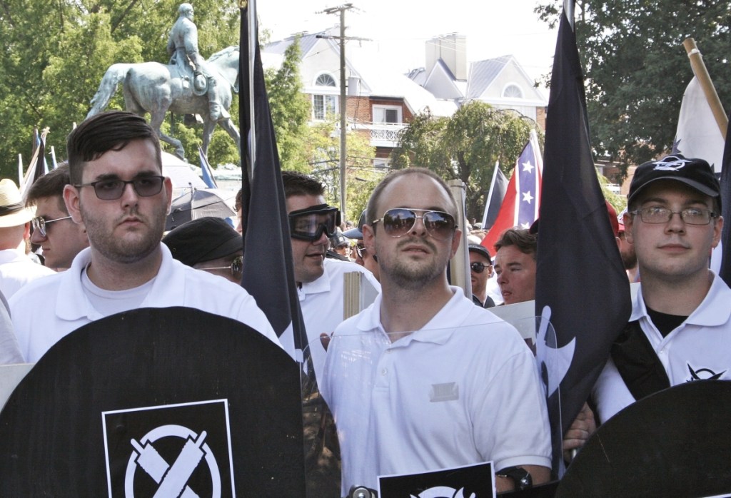 James Alex Fields Jr., left, holds a black shield in Charlottesville, Va., where a white supremacist rally took place. Fields Jr., of Maumee, Ohio, was convicted of first-degree murder for driving his car into a crowd of people protesting against white nationalists.